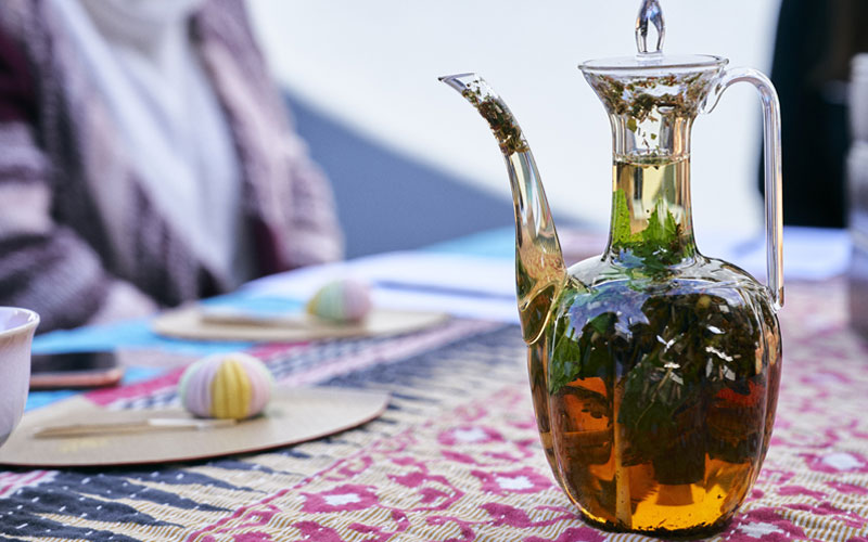 A glass tea pot on a table