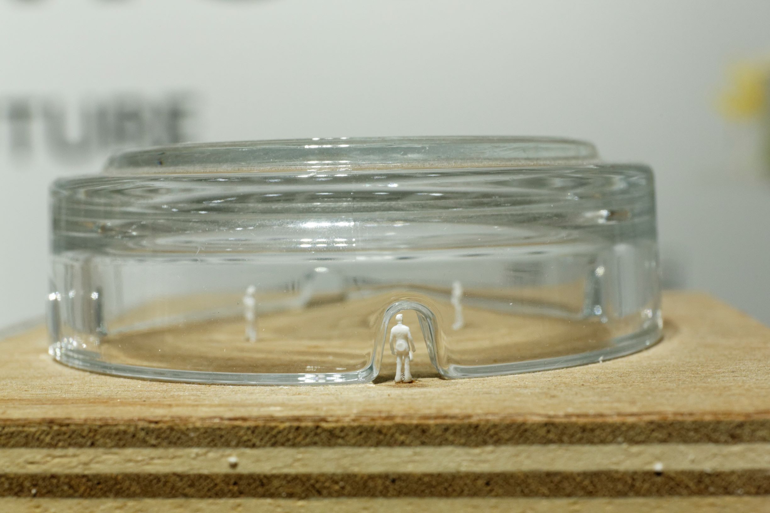 figurines inside an overturned glass ashtray