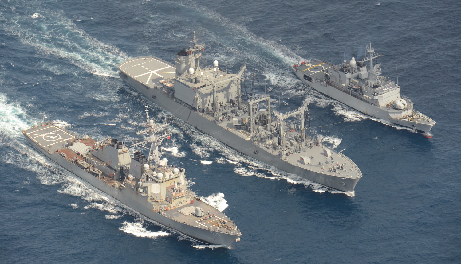 Image of the USS Curtis Wilbur, DDG 54 (left) conducts a replenishment-at-sea with the Japan Maritime Self-Defense Force replenishment ship JS Hamana, AOE 424 (center) and French light frigate FNS Prairial, F731 (right)