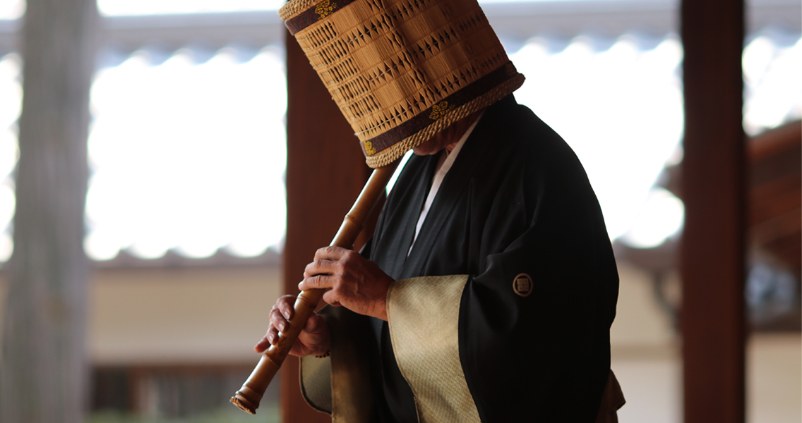 A man playing the shakuhachi flute
