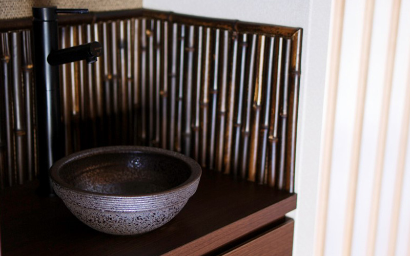 A sink and bowl made with black bamboo