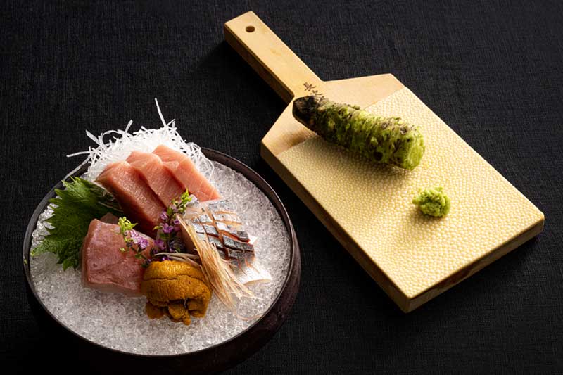 A variety of sashimi on a plate and wasabi