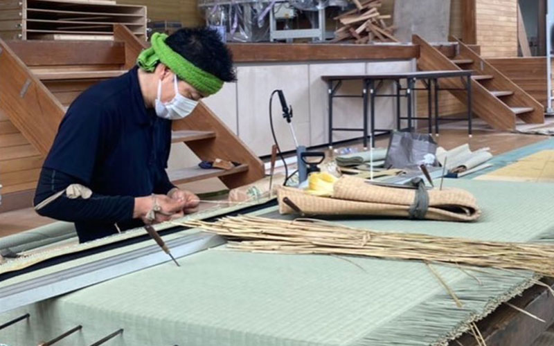 A craftsman making tatami