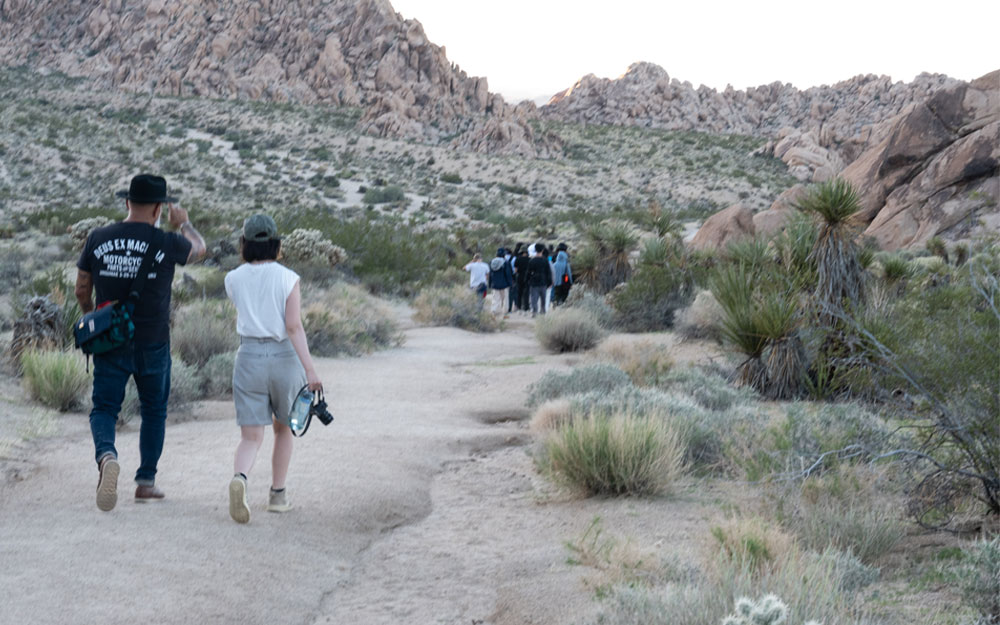 A group of people walking on a dirt path