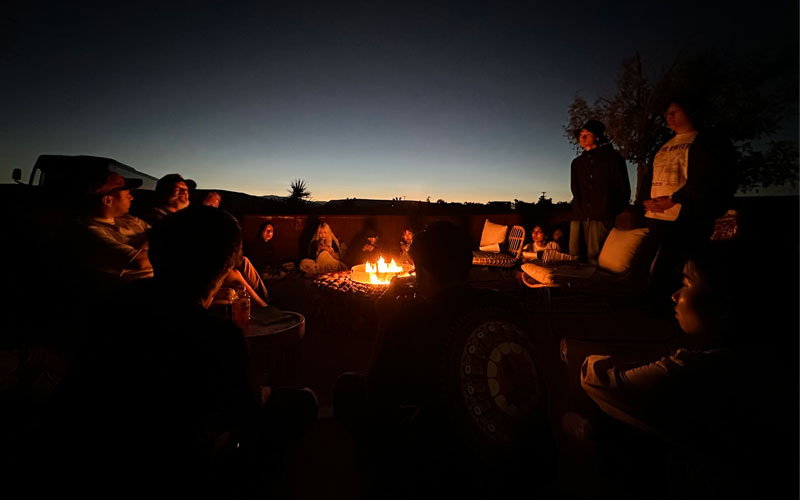 A group of people around a fire pit