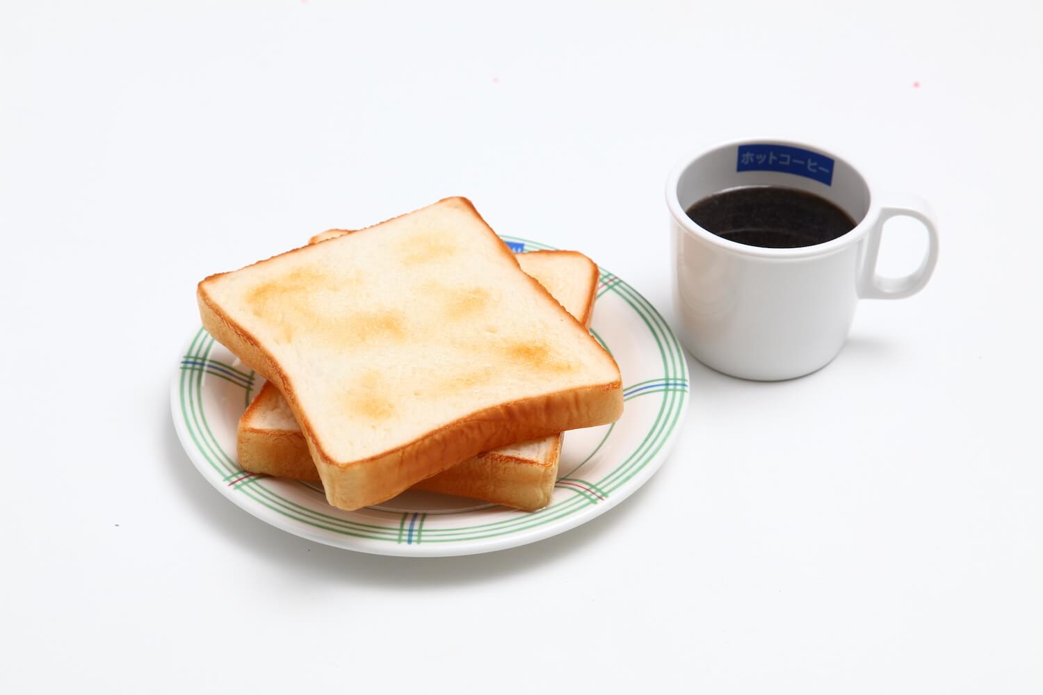 Realistic food replica of toast with butter on a plate and a mug with coffee