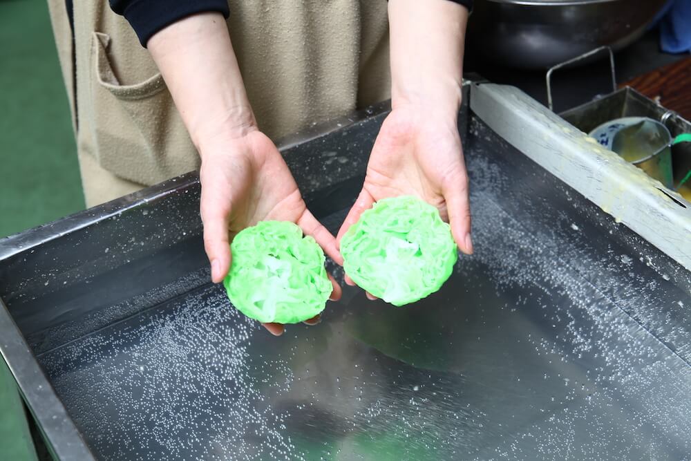 Fake lettuce cut in half, revealing detailed layers and realistic texture inside.